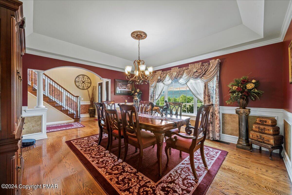 3209 Crest Vue Circle Danielsville, PA 18038 - Photo 23 of 95 a view of a dining room with furniture a chandelier and wooden floor