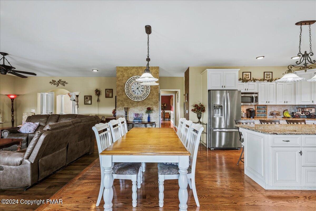 3209 Crest Vue Circle Danielsville, PA 18038 - Photo 30 of 95 a view of a dining room with furniture a kitchen and chandelier