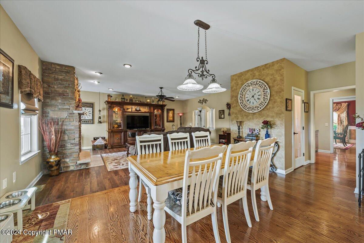 3209 Crest Vue Circle Danielsville, PA 18038 - Photo 31 of 95 a view of a dining room with furniture wooden floor and a clock