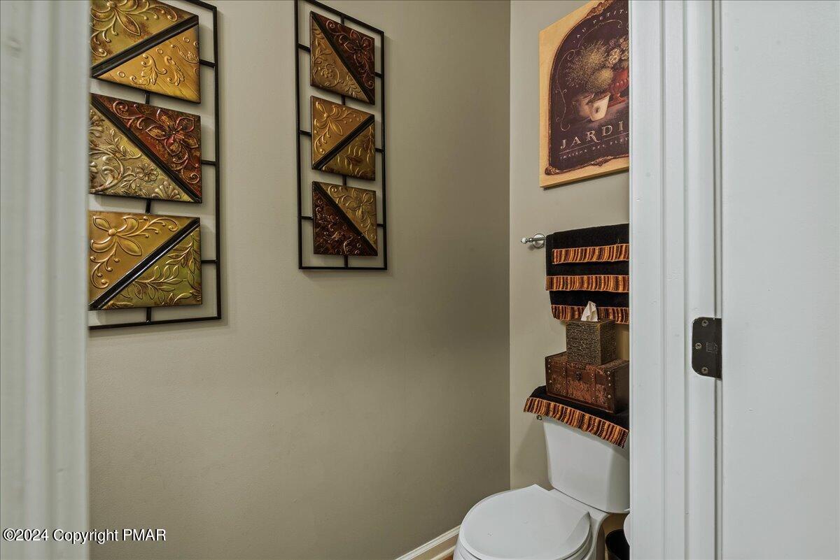 3209 Crest Vue Circle Danielsville, PA 18038 - Photo 43 of 95 a white toilet sitting next to a shower curtain