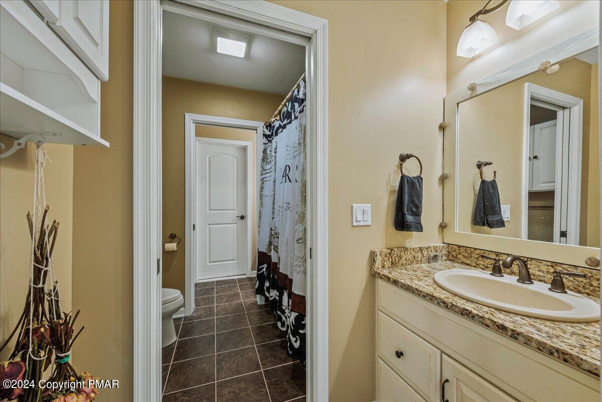 3209 Crest Vue Circle Danielsville, PA 18038 - Photo 59 of 95 a bathroom with a granite countertop sink a mirror and a shower