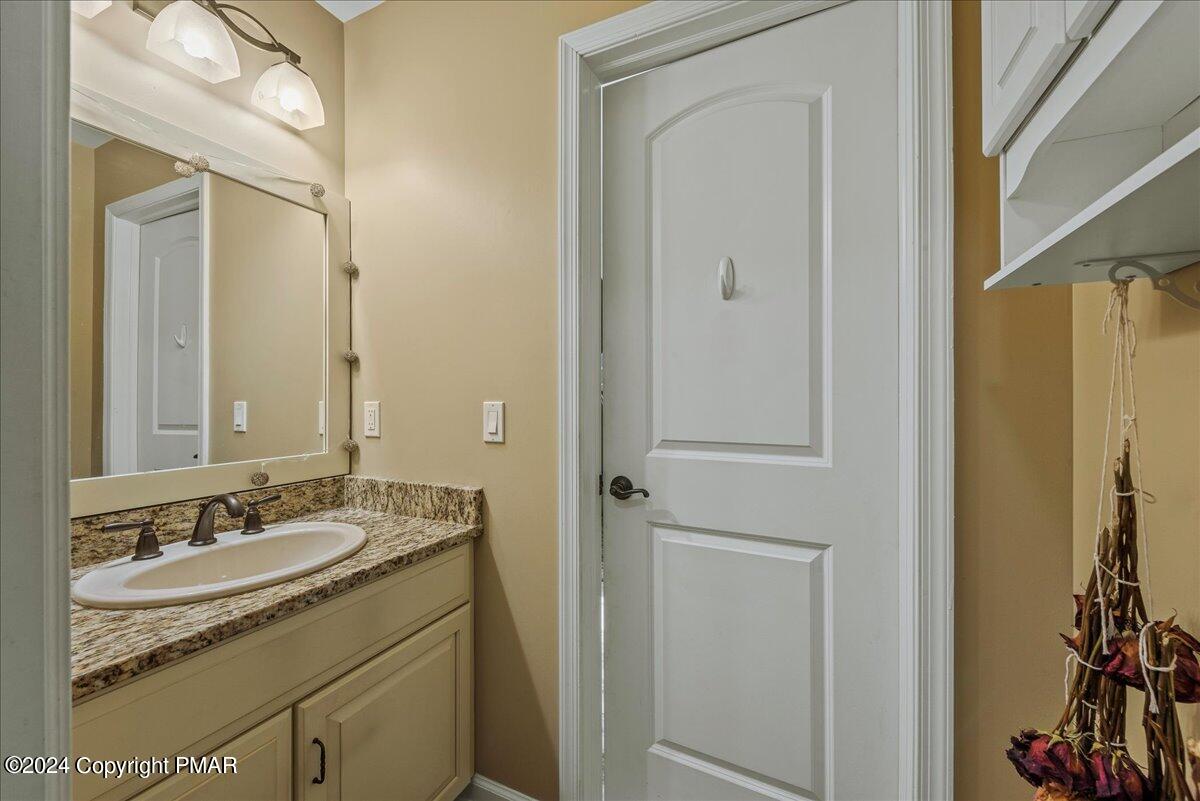 3209 Crest Vue Circle Danielsville, PA 18038 - Photo 60 of 95 a bathroom with a granite countertop sink a mirror and a shower