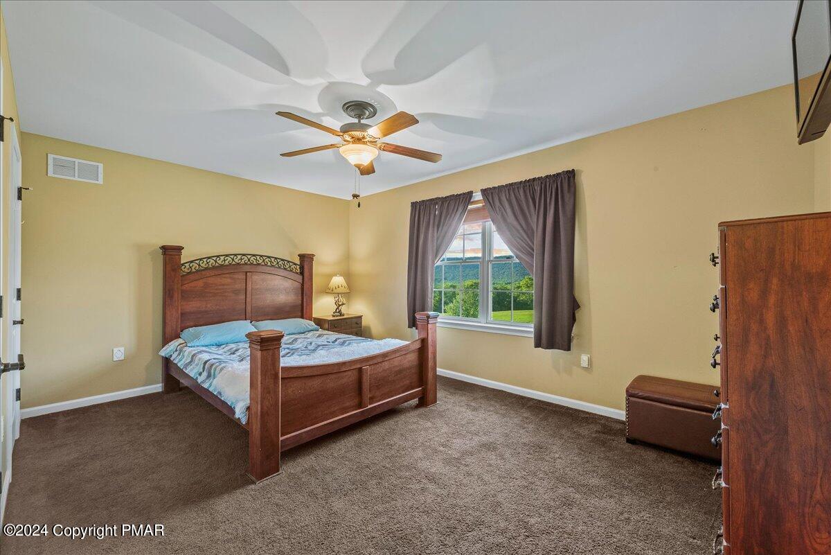 3209 Crest Vue Circle Danielsville, PA 18038 - Photo 64 of 95 a bedroom with a bed and a chandelier