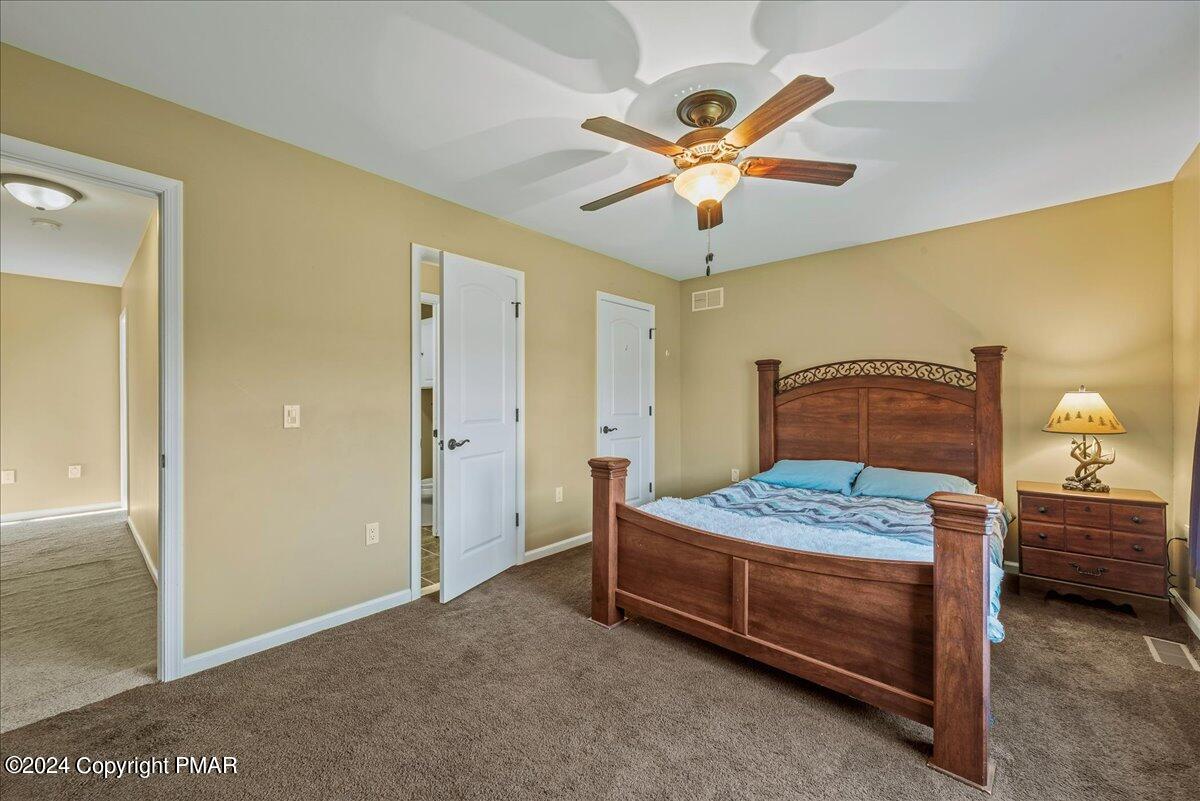 3209 Crest Vue Circle Danielsville, PA 18038 - Photo 65 of 95 a bedroom with a bed and a chandelier