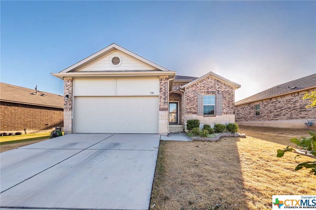 1701 Atlas Road Cedar Park, TX 78613 - Photo 1 of 1 a front view of a house with a yard and garage