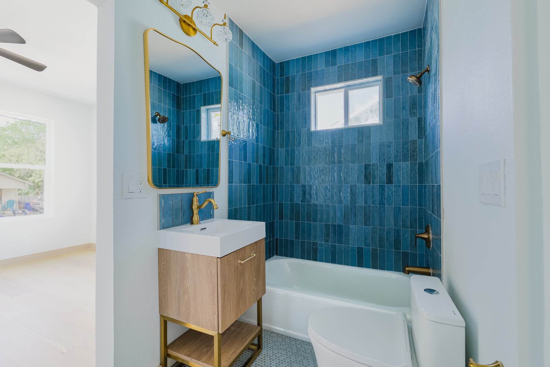 1905 East 21st Street Austin, TX 78722 - Photo 13 of 27 a bathroom with a sink a bathtub and a shower