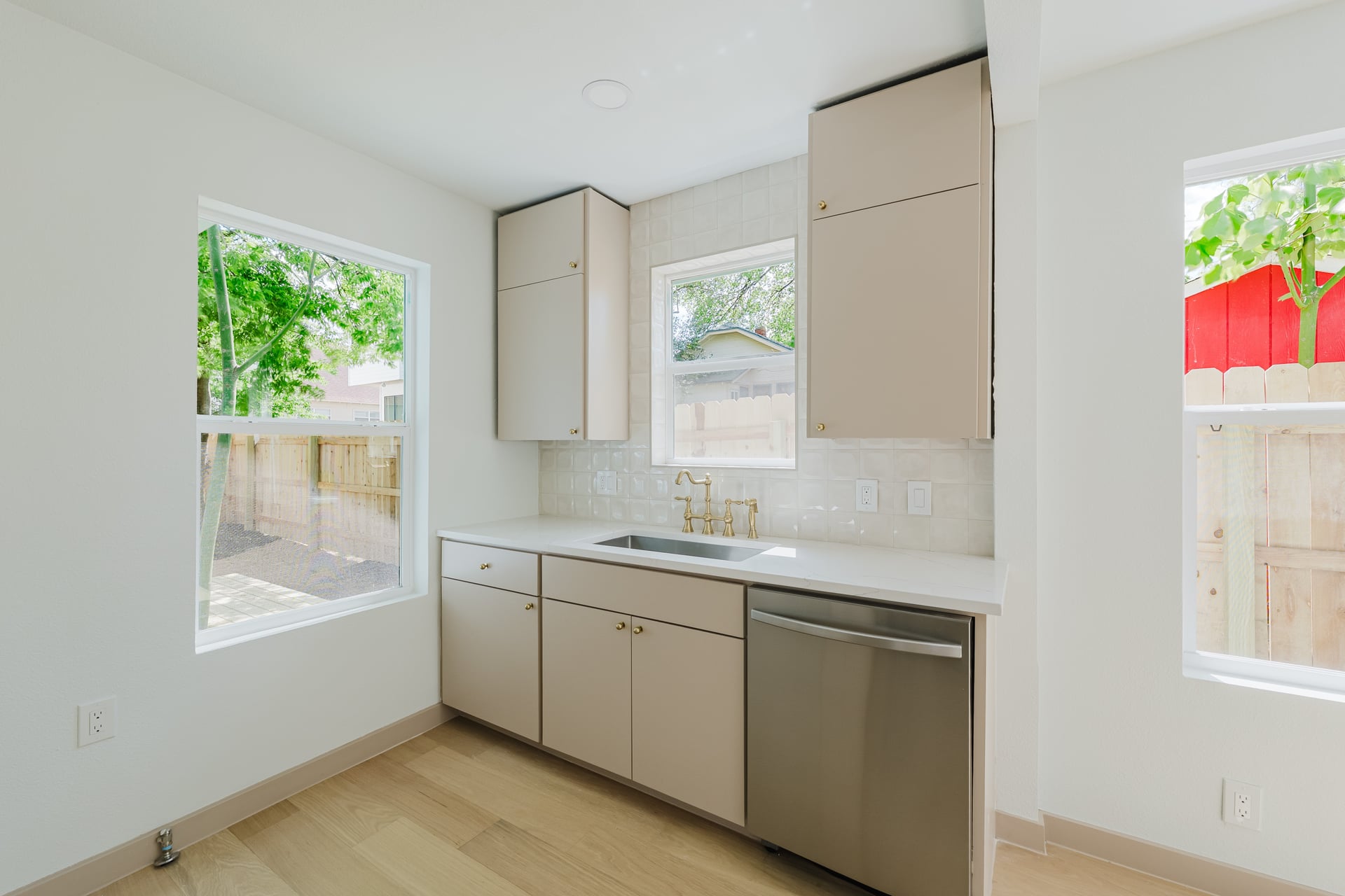 1905 East 21st Street Austin, TX 78722 - Photo 9 of 27 a kitchen with a sink window and cabinets
