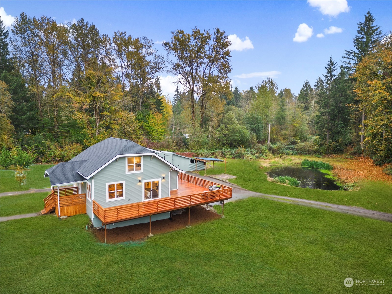 18847 Southeast Lake Youngs Road Renton, WA 98058 - Photo 36 of 38 a house that is sitting in the grass with large trees