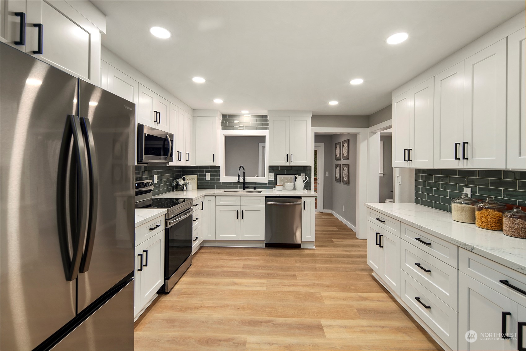 18847 Southeast Lake Youngs Road Renton, WA 98058 - Photo 6 of 38 a large kitchen with stainless steel appliances and refrigerator