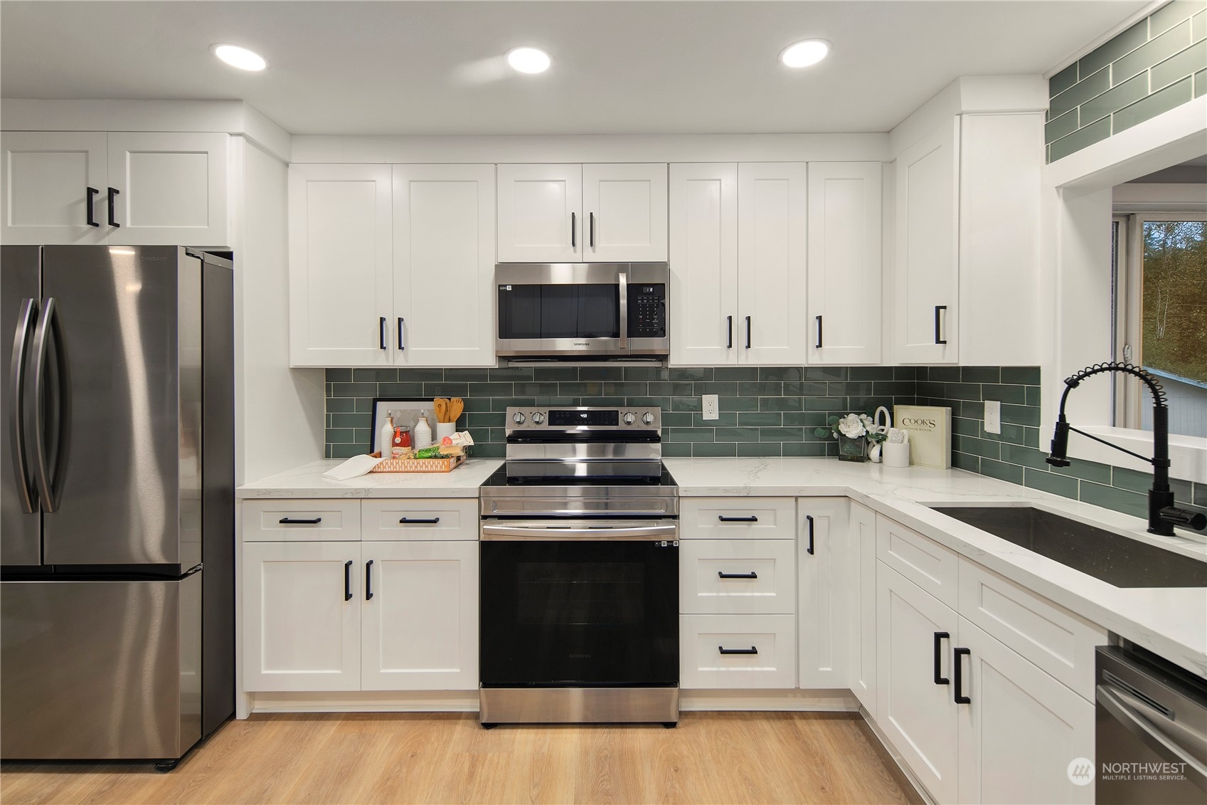 18847 Southeast Lake Youngs Road Renton, WA 98058 - Photo 8 of 38 a kitchen with white cabinets and stainless steel appliances