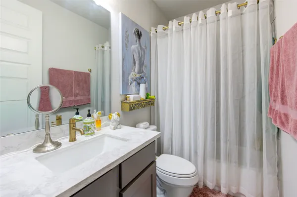 a large kitchen with stainless steel appliances kitchen island granite countertop a large counter top a stove and a sink