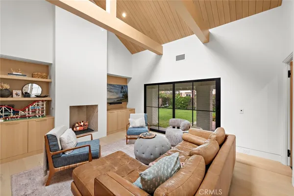 a living room with furniture and a floor to ceiling window
