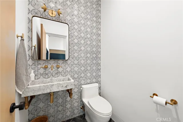 a bathroom with a toilet sink and mirror