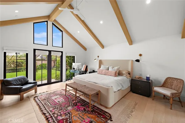 a living room with a bed furniture and a large window