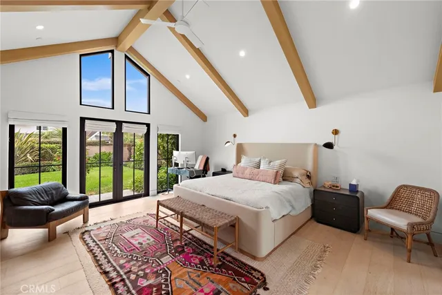 a living room with a bed furniture and a large window