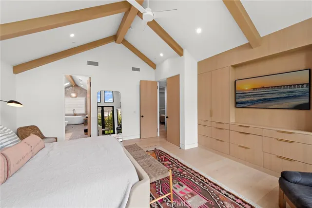 a bedroom with a bed and dresser with mirror