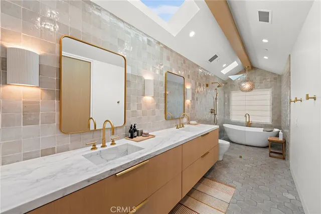 a large bathroom with a double vanity sink and mirror with shower