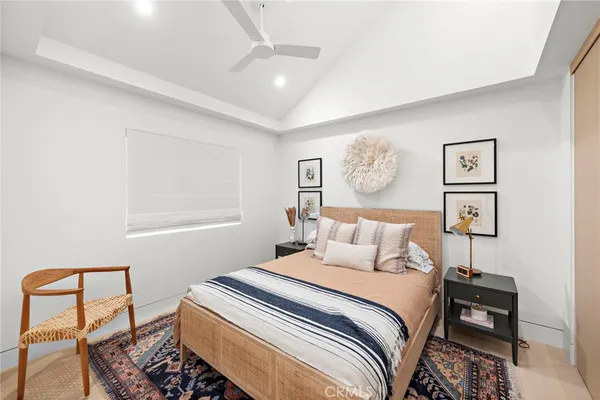 a bedroom with a bed and painting on the wall