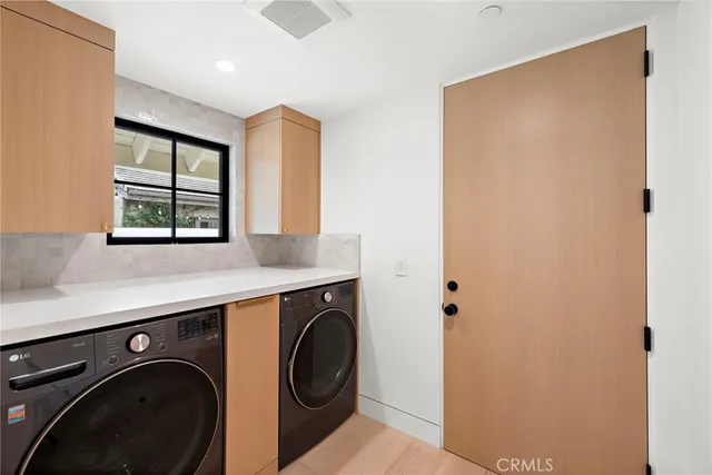 a view of a storage and utility room with washer and dryer