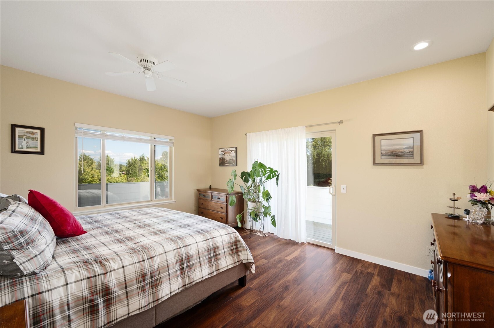 3167 Unick Road Ferndale, WA 98248 - Photo 12 of 40 a bedroom with a large bed and a potted plant