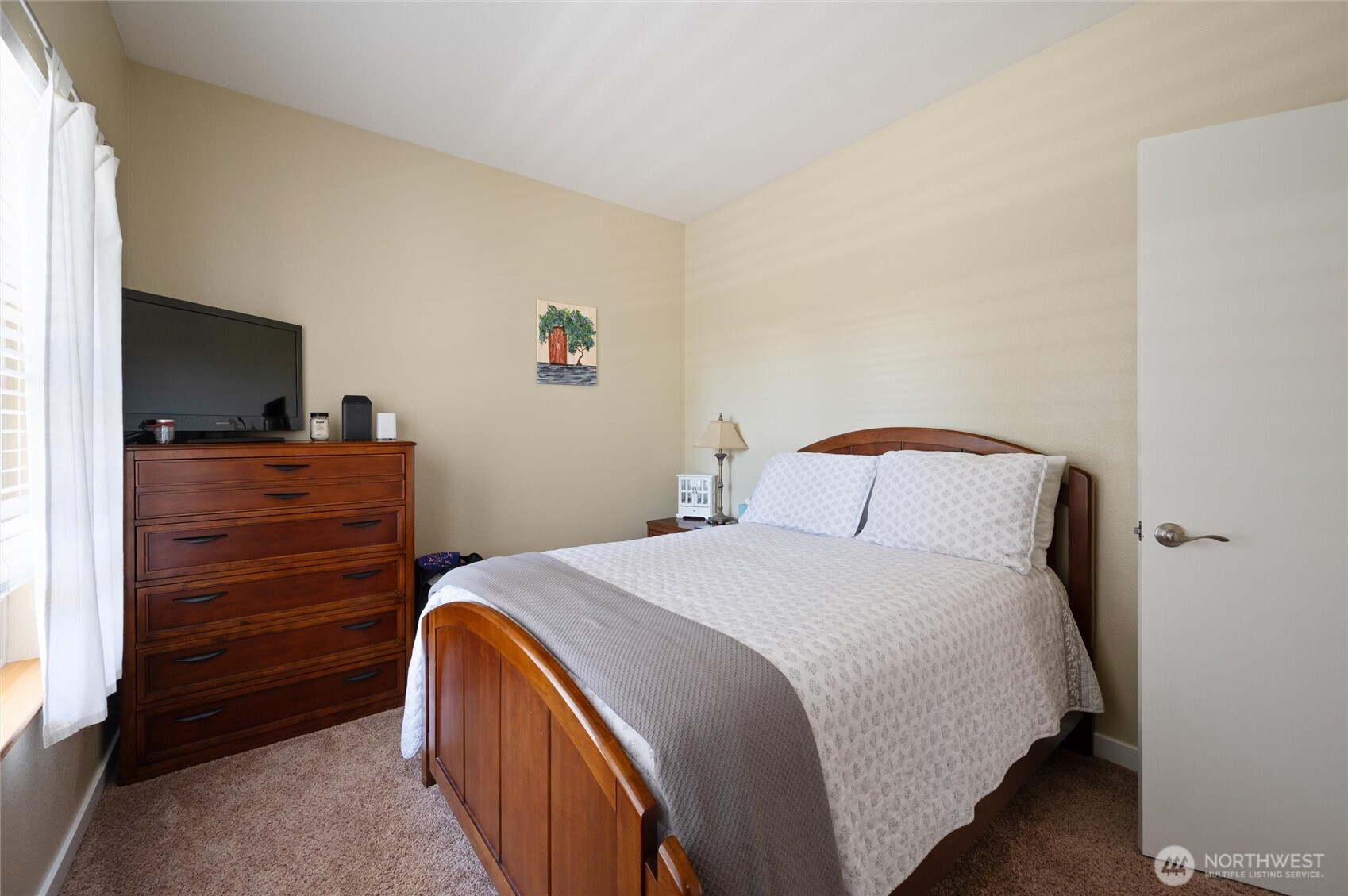 3167 Unick Road Ferndale, WA 98248 - Photo 17 of 40 a bedroom with a bed and a flat tv screen on a dresser