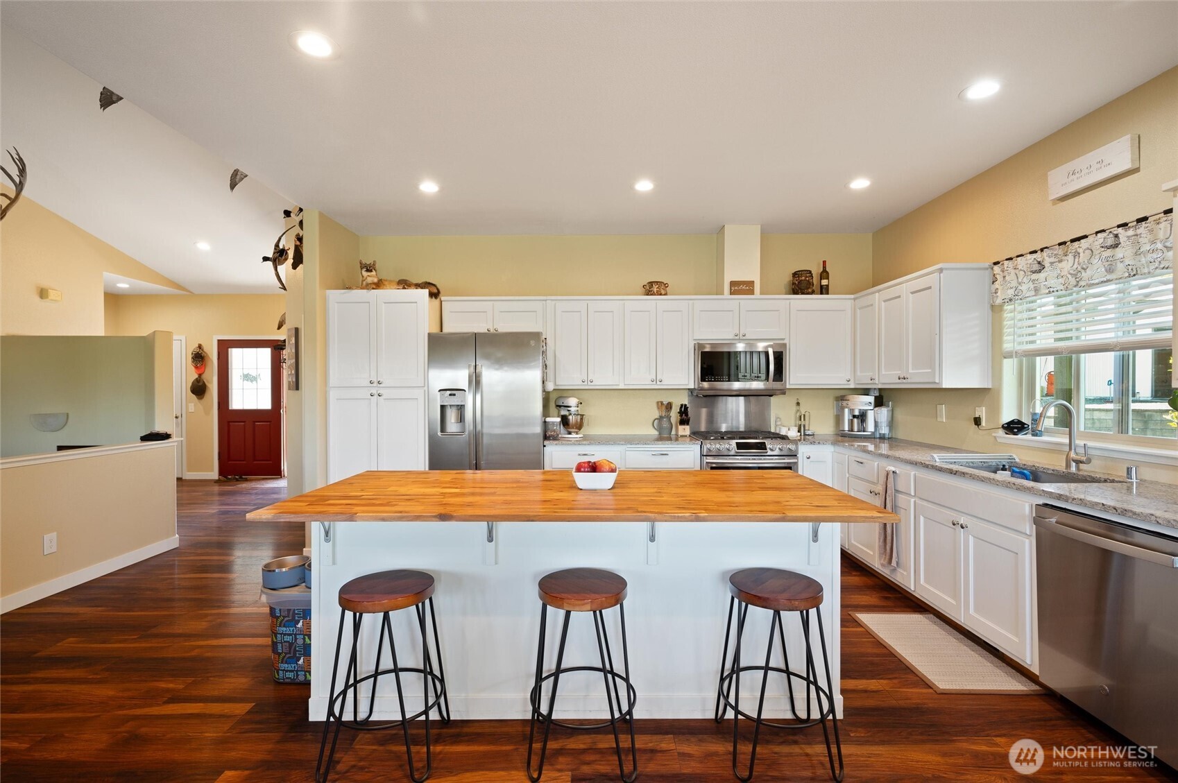 3167 Unick Road Ferndale, WA 98248 - Photo 6 of 40 a kitchen with stainless steel appliances kitchen island granite countertop a kitchen island and chairs in it