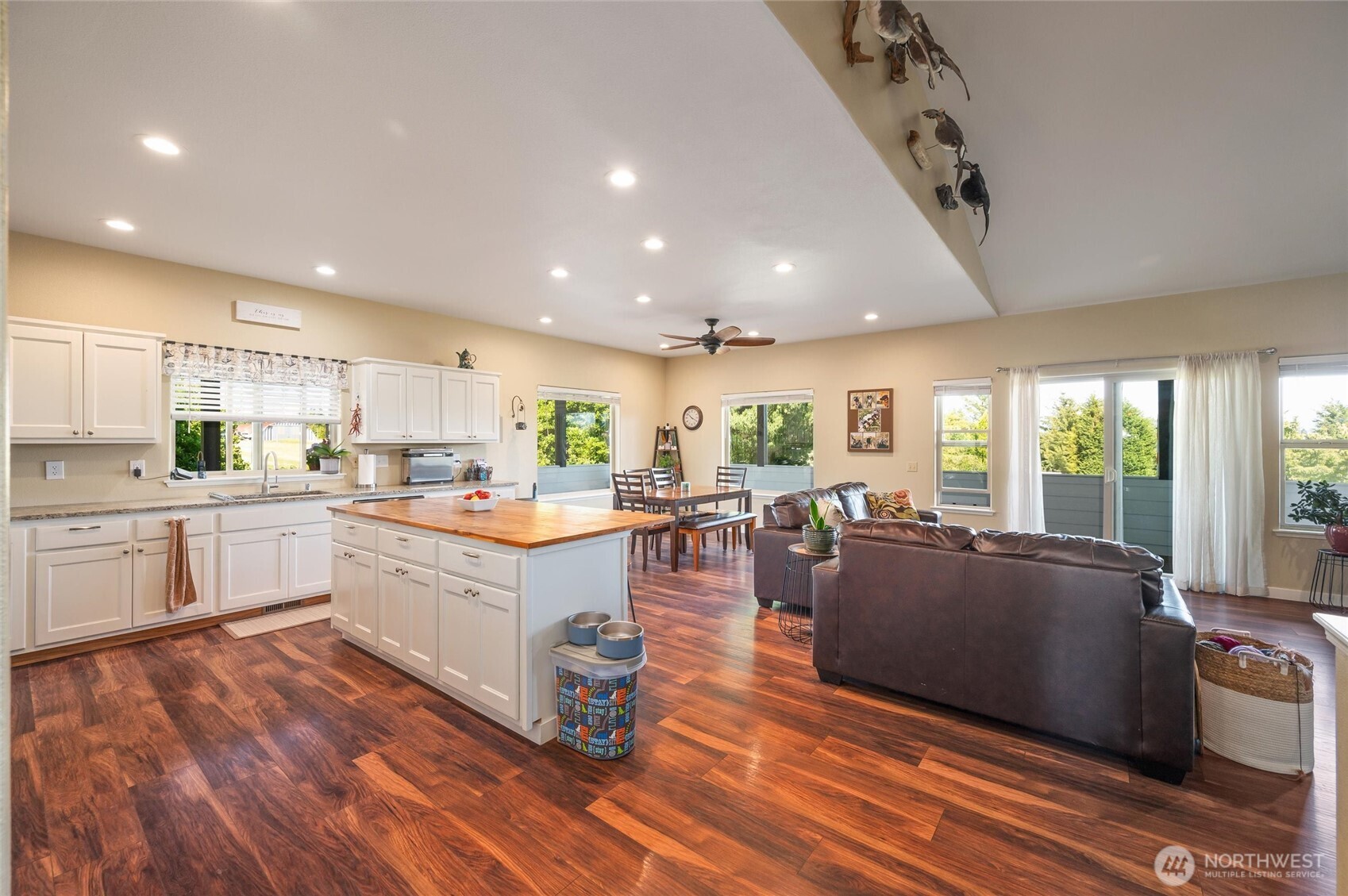 3167 Unick Road Ferndale, WA 98248 - Photo 9 of 40 a large white kitchen with lots of counter space wooden floor and stainless steel appliances