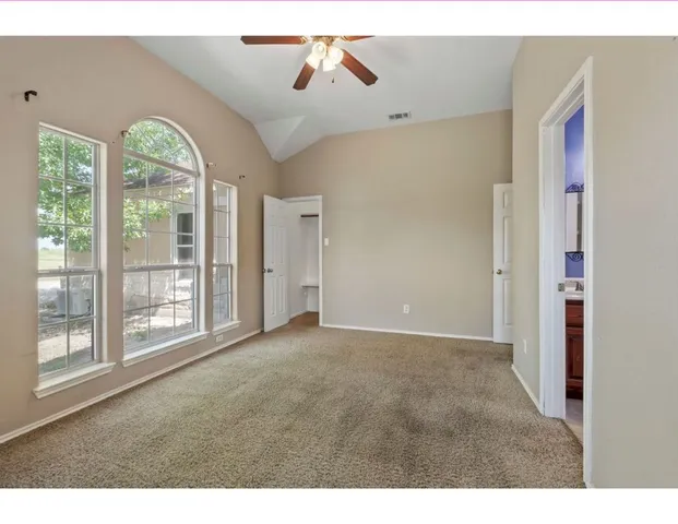 a view of a livingroom with a ceiling fan and window