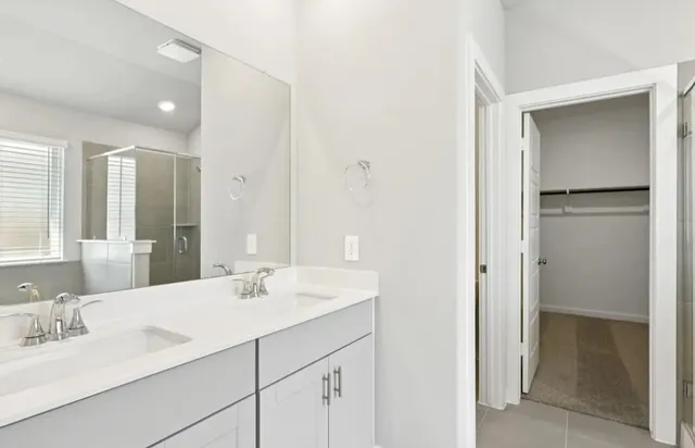 a bathroom with a sink vanity and a mirror
