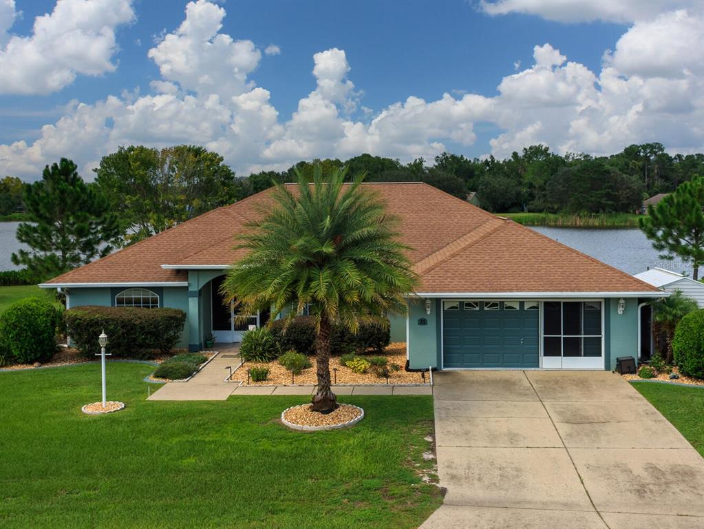 21 Hickory Loop Ocala, FL 34472 - Photo 1 of 1 a front view of a house with garden