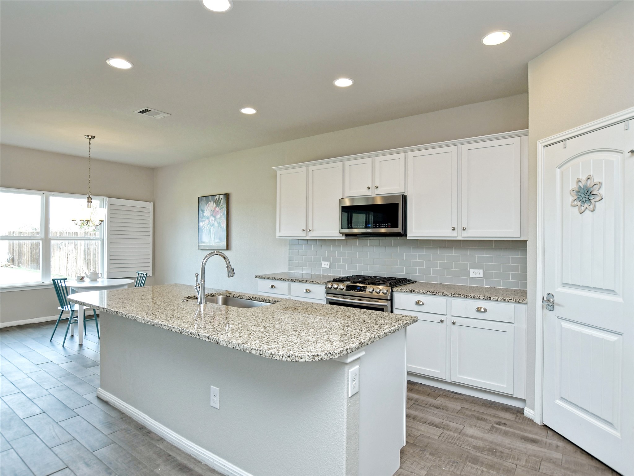 4317 Buffalo Ford Road Georgetown, TX 78628 - Photo 5 of 37 Kitchen- Dining, White Cabinets and Stainless Steel Appliances