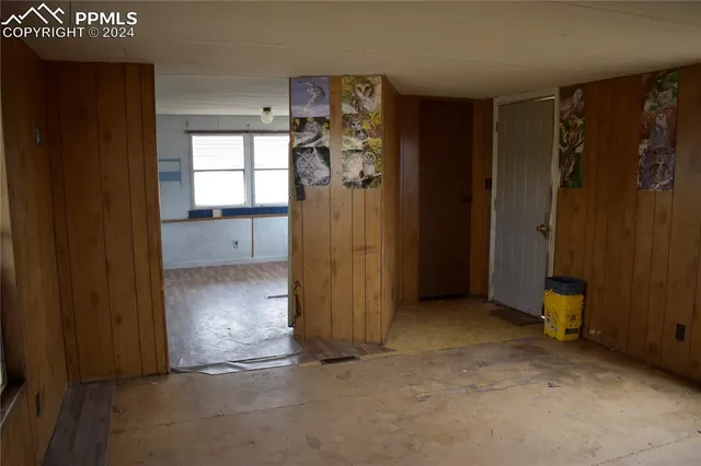 an empty room with closet and windows