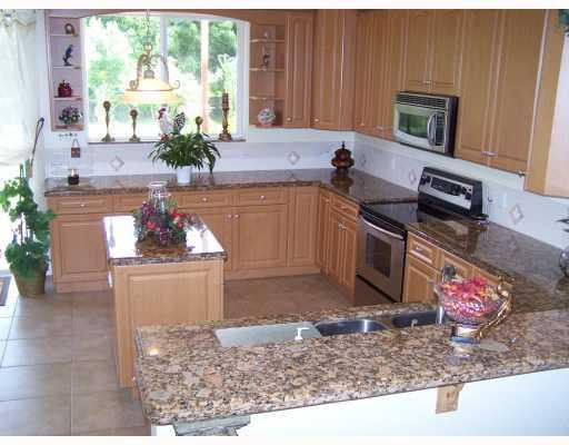 19100 Southwest 63rd Street Southwest Ranches, FL 33332 - Photo 5 of 9 a kitchen with a stove a sink and a microwave