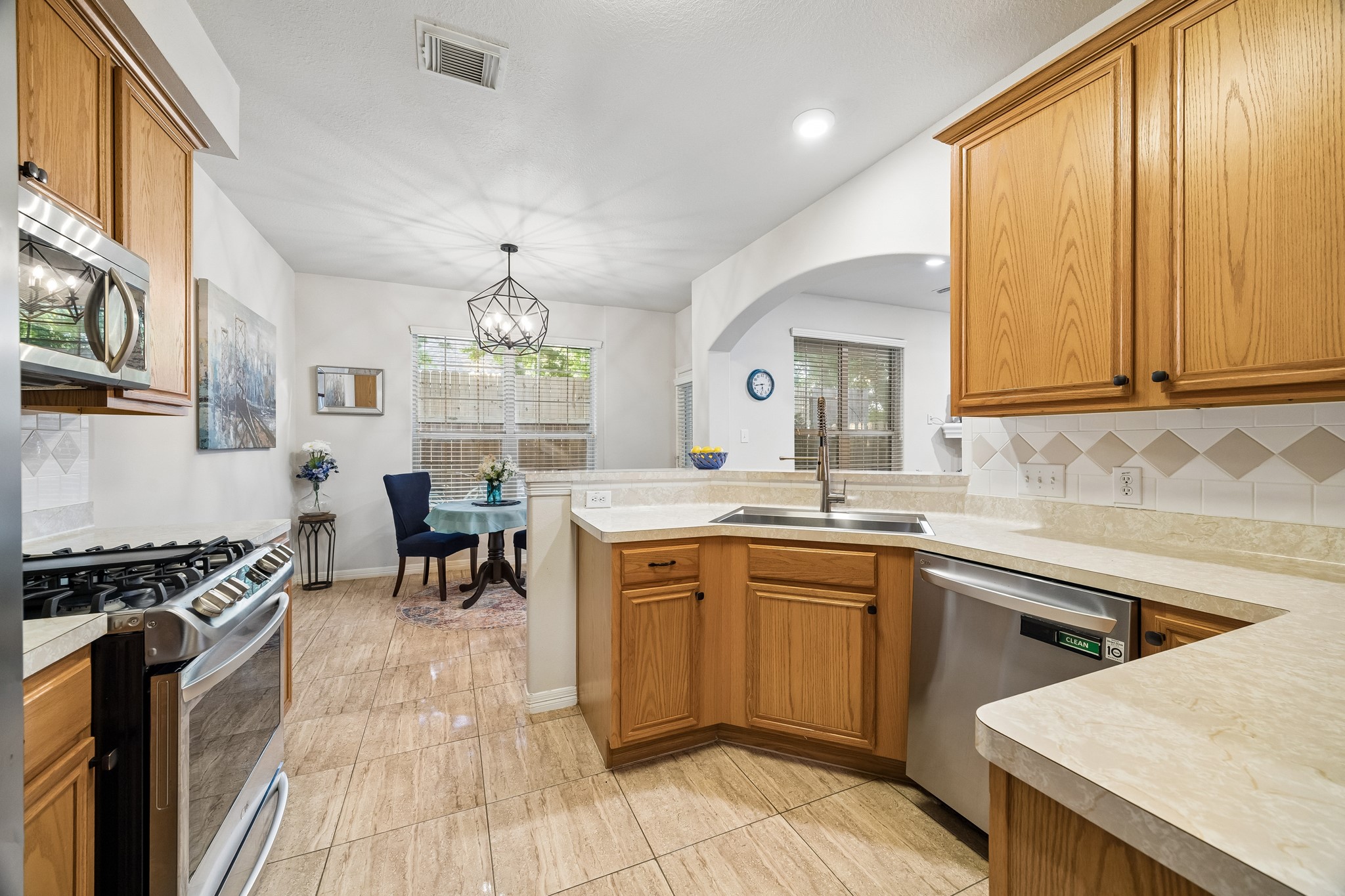 7618 North Linpar Court Houston, TX 77040 - Photo 7 of 34 Notice the deep stainless steel sink! The kitchen has ample counter space. Easy view of the breakfast room and out into the Private courtyard. All Appliances remain with the home!