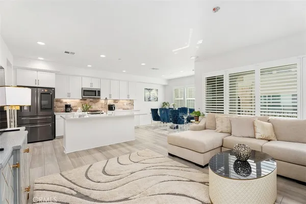 a living room with furniture and kitchen view