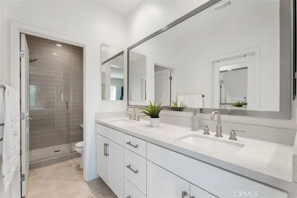 a bathroom with a granite countertop sink mirror and shower