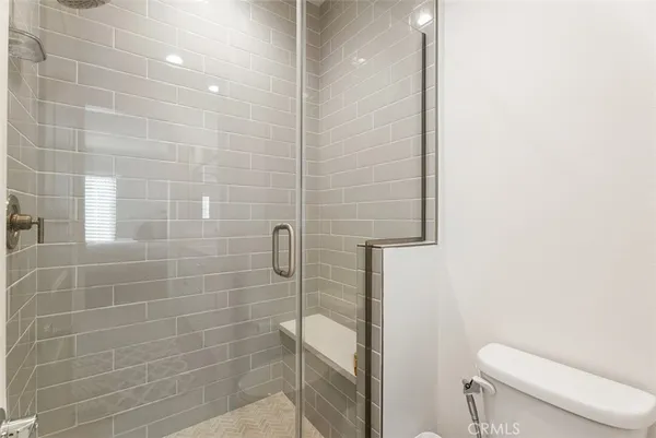 a bathroom with a toilet and a shower