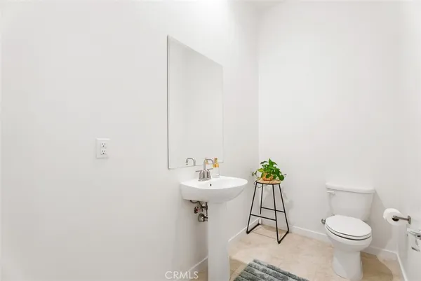a bathroom with a sink toilet and a mirror