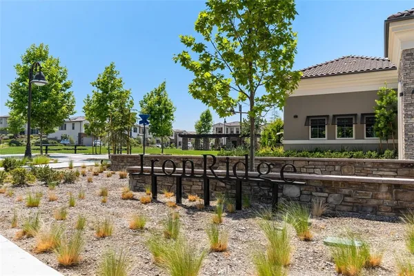 a view of house with swimming pool and outdoor seating