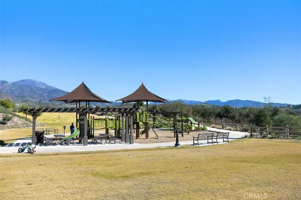 a view of a patio with table and chairs with wooden floor and fence