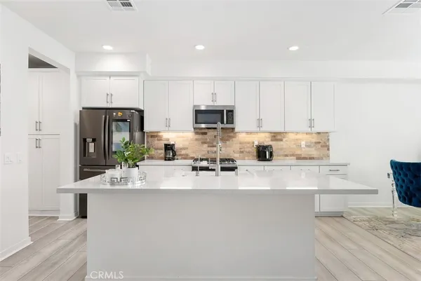 a view of kitchen with refrigerator stove and microwave