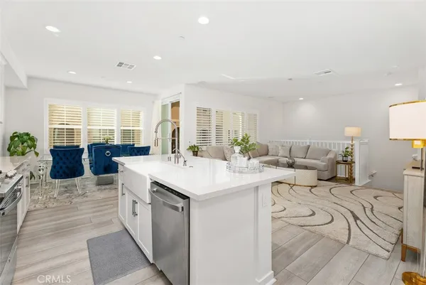 a large white kitchen with a large window
