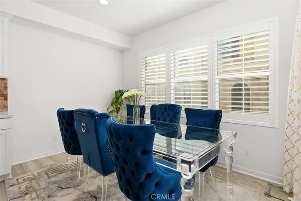 a view of a dining room with furniture and a window