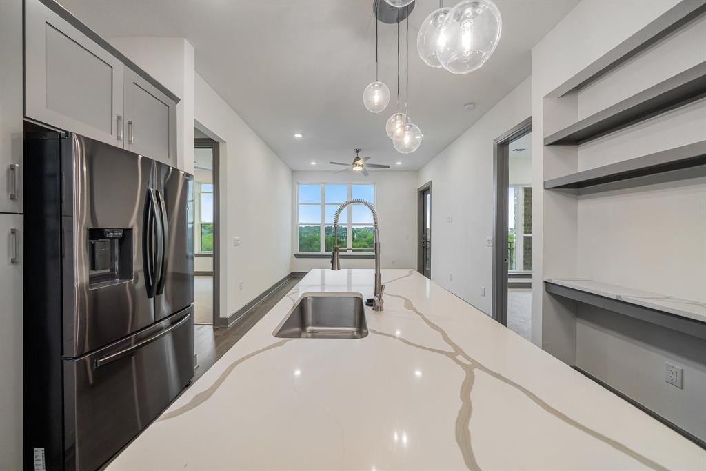2700 Old Denton Road, Unit 3336 Carrollton, TX 75007 - Photo 10 of 28 a kitchen with stainless steel appliances a refrigerator and a stove top oven