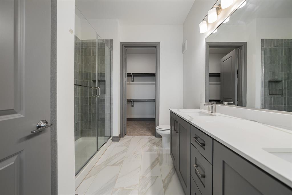 2700 Old Denton Road, Unit 3336 Carrollton, TX 75007 - Photo 17 of 28 a bathroom with a sink a mirror and a shower