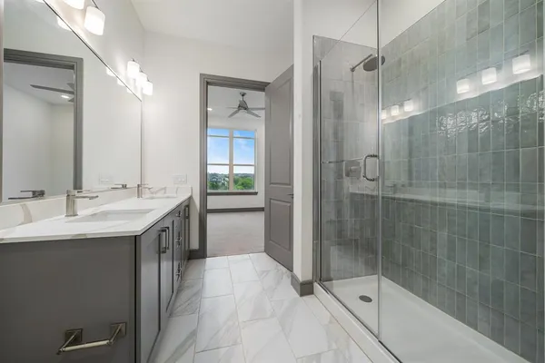 a bathroom with a shower sink and mirror
