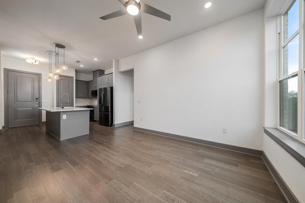 2700 Old Denton Road, Unit 3336 Carrollton, TX 75007 - Photo 5 of 28 an open kitchen with a refrigerator and white cabinets