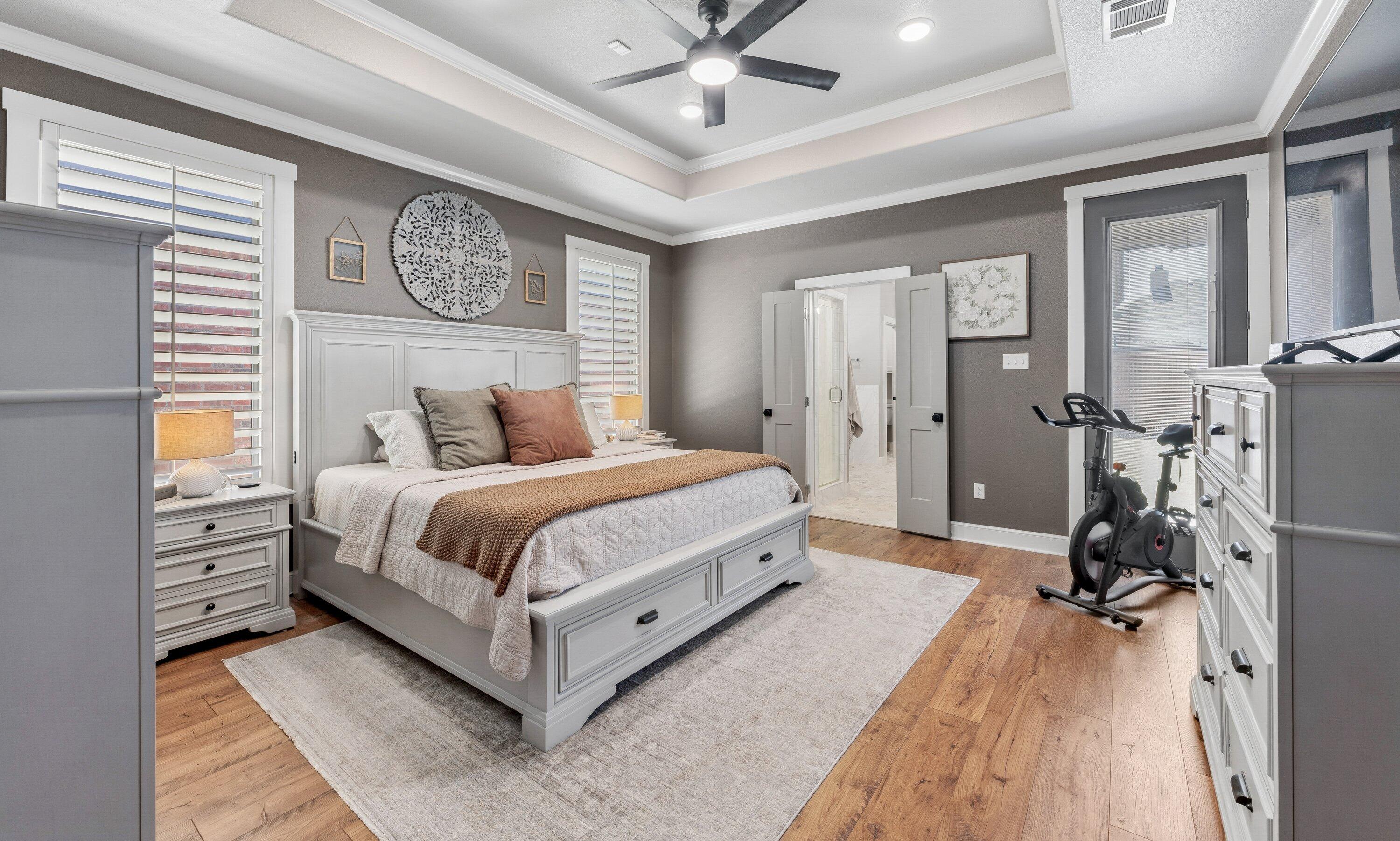 629 North 9th Street Wolfforth, TX 79382 - Photo 19 of 45 a bedroom with a bed and a chandelier