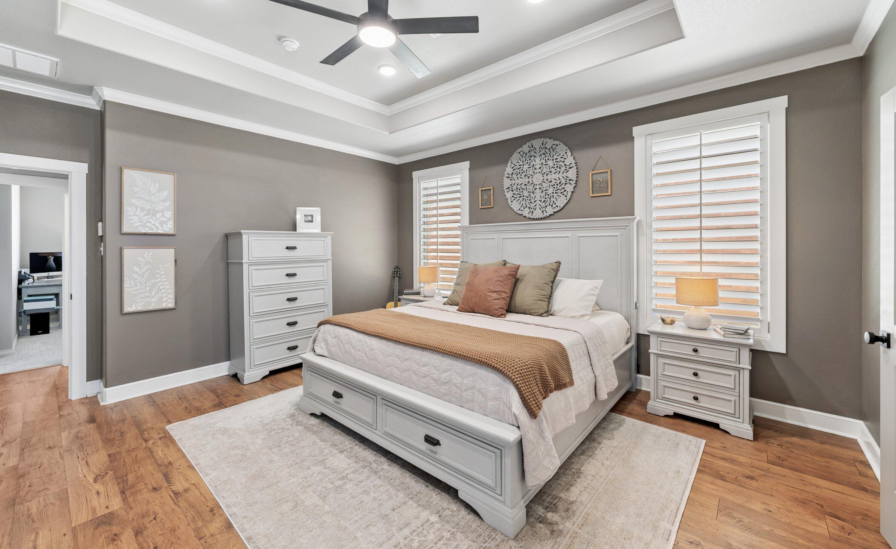 629 North 9th Street Wolfforth, TX 79382 - Photo 21 of 45 a bedroom with a bed and a chandelier