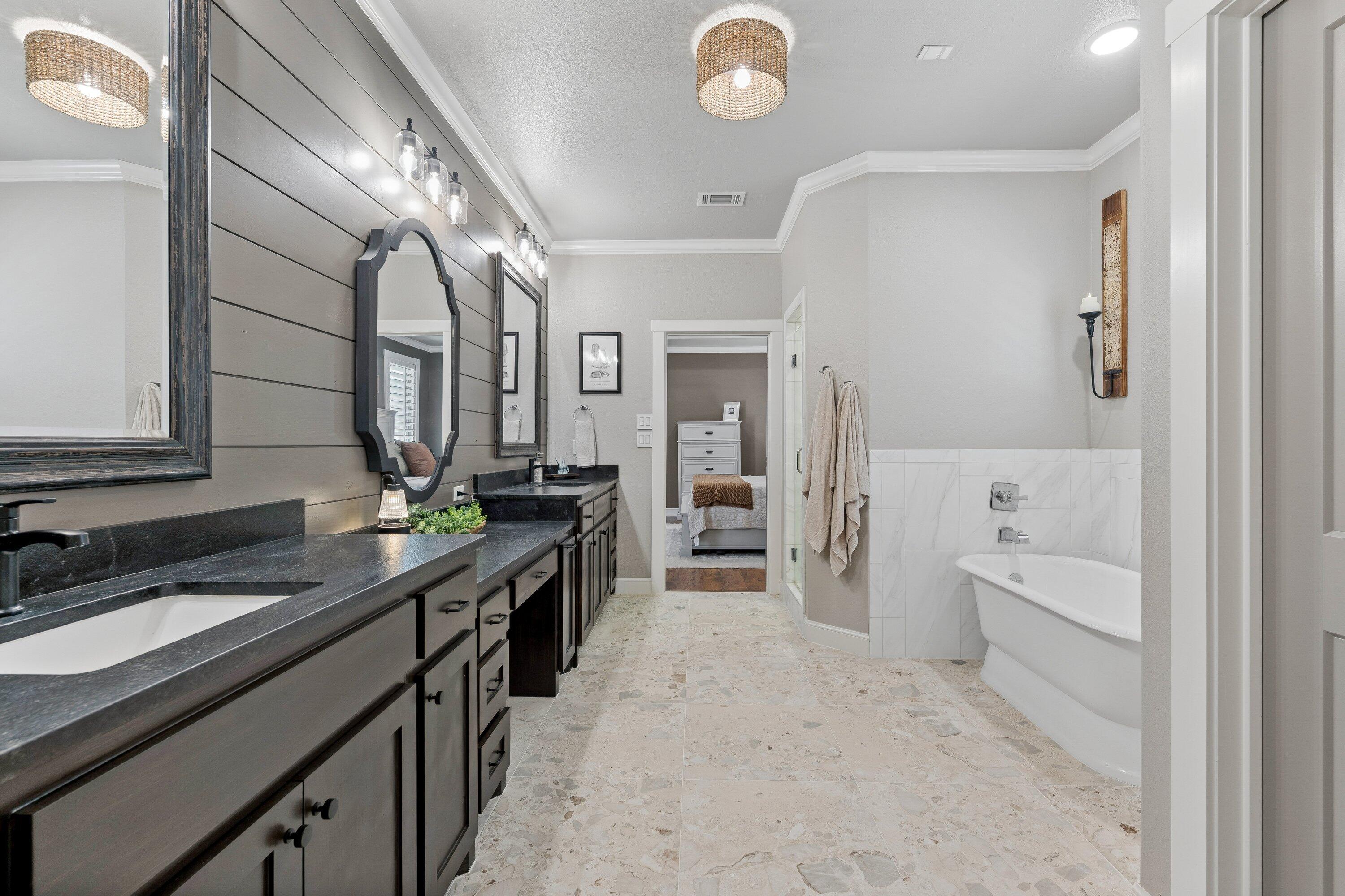 629 North 9th Street Wolfforth, TX 79382 - Photo 25 of 45 a spacious bathroom with a double vanity sink a mirror and a bathtub